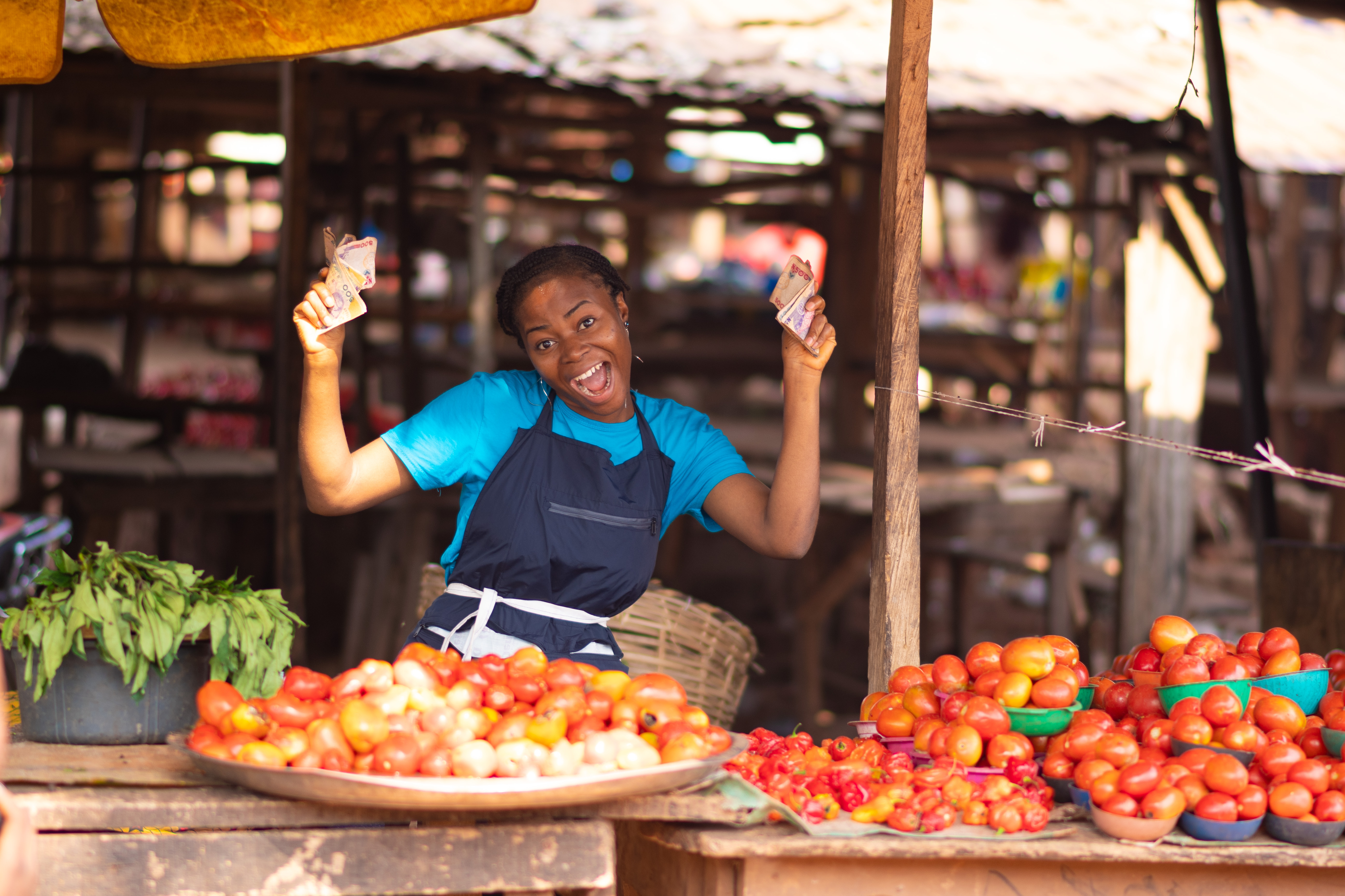 african,market,woman,holding,money,,feeling,excited,and,happy